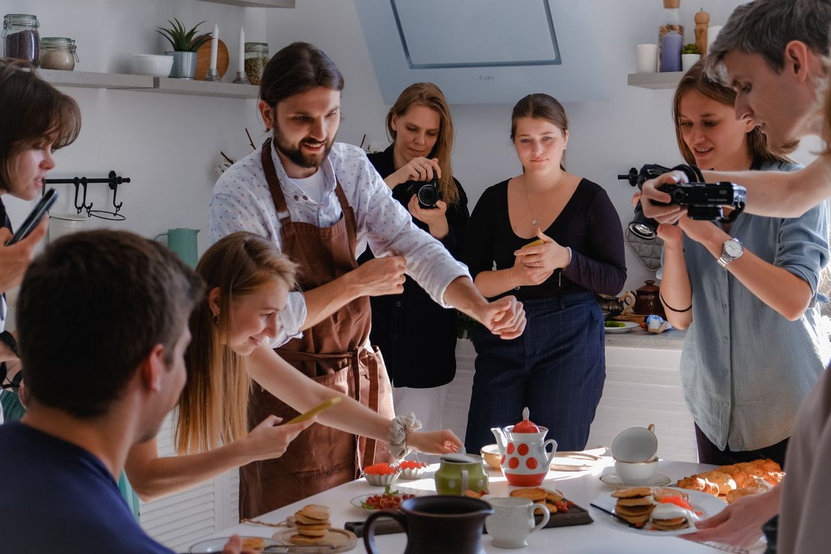 A group cooking with a chef at a cooking workshop
